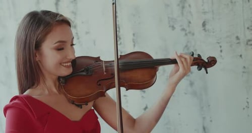 Close View of Duet of Admiring Female Musicians in Dresses Playing the Violins