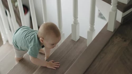 Baby Crawling Up Stairs in Bright Home