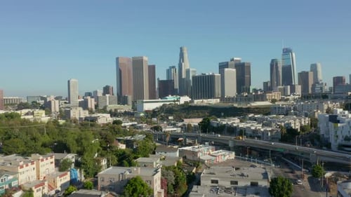 AERIAL: Flying Away From Downtown Los Angeles, California Skyline at Beautiful Blue Sky and Sunny