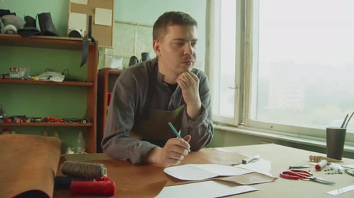 Leather Craftsman Designing Shoes in Workshop