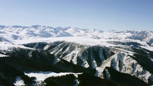 Snowy Mountain Range with Evergreen Forest Aerial View