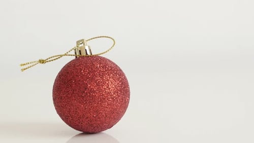 Close-up of decorative red bauble with sequins 4K 2160p 30fps UltraHD tilting footage - Shiny Chr