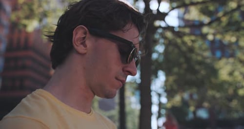 Man Using Smartphone Outdoors in Urban Park