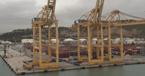 Aerial View. Seaport and Loading Docks at the Port with Cranes and Multi-colored Cargo Containers.