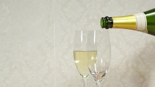Pouring Champagne into Flute Glasses for Celebration