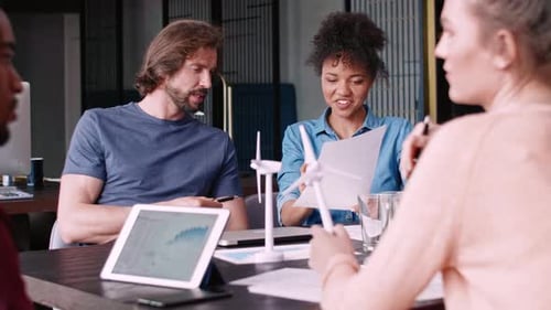 Team Discussing Renewable Energy at Workplace Meeting