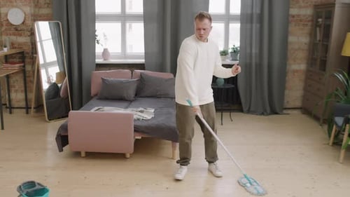 Man Dancing While Cleaning House