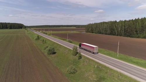 Aerial view of truck driving on a straight asphalt road 05