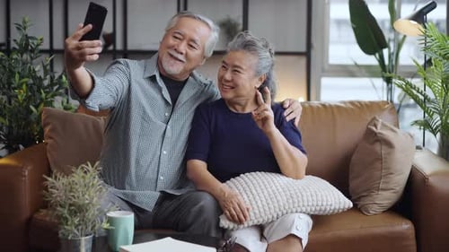 Senior Couple Taking Selfie Together in Cozy Home