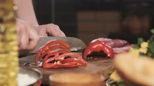 Chef in Restaurant Kitchen Cut Red Pepper with Sharp Shiny Knife