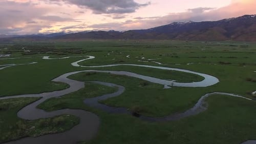 Luftaufnahme über Fluss, der sich durch grüne Landschaft schlängelt