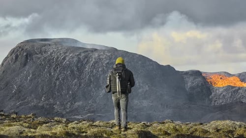 Man Walking Towards Lava Flow From Erupting Fagradalsfjall Volcano