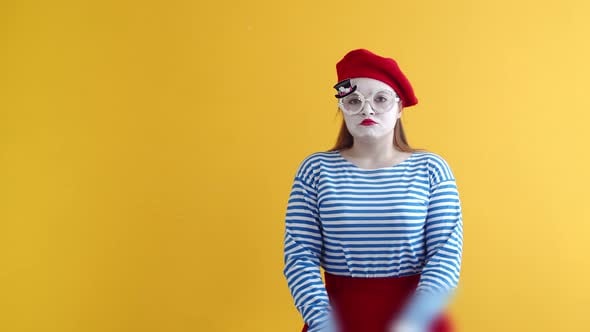Mime Expression Woman in Striped Suit on an Orange Background Makes a ...