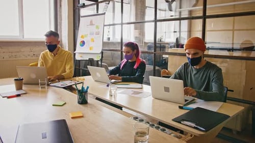 Coworkers Working at Table in Modern Office