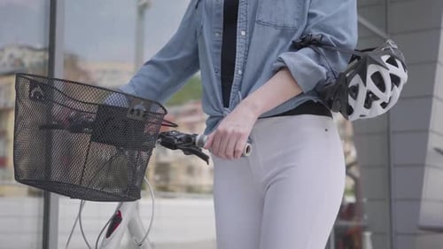 Unrecognized Young Sport Slim Attractive Blond Woman in White Jeans Leading Her Bicycle Near the