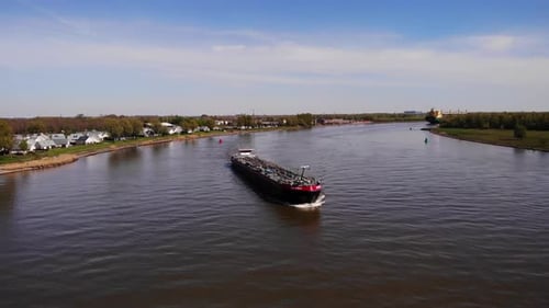 Tankship Travelling Across The River At Daytime. Shipping Vessel. aerial