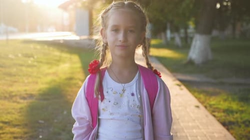 Teenage Girl with Backpack in Sun Rays. Happy Smiling Teen with Braided Hair Go To School in Flare