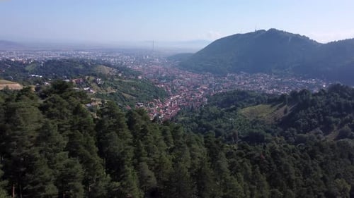 The Medieval European Village with Orange Roofs is Lying Beside the Mountain