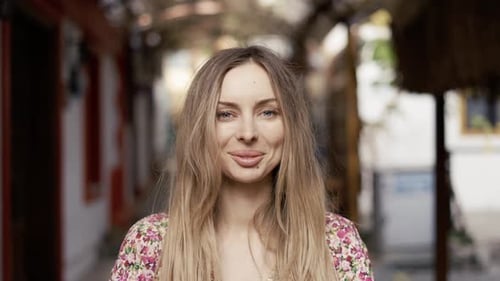 Blonde Woman Smiling in Urban Setting