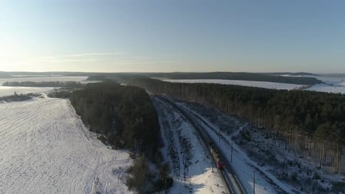Freight train travels by rail from far away and approaches the camera 12