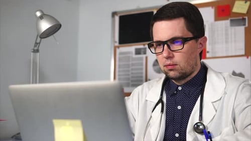Doctor Prints the Text on the Laptop in His Private Office in Clinic