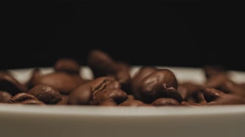 Coffee Beans Pouring onto Surface in Close Up