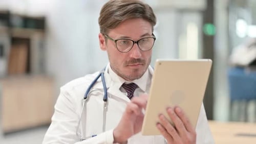 Male Doctor Using a Tablet in Medical Setting