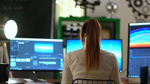 Woman Video Editor Working at Computer in Office