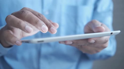 Businessman Using Digital Tablet on Office Desk