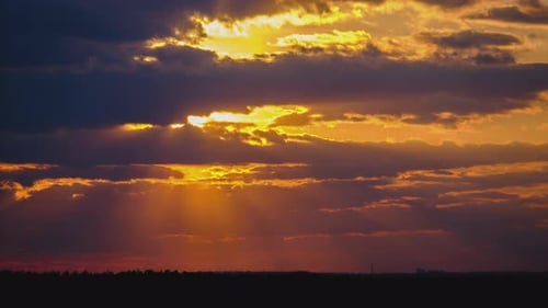 Sunset in the Sky Through Yellow Layered Clouds Timelapse