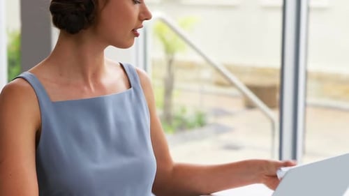 Woman Working and Smiling During Phone Call