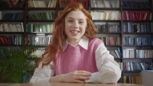 Young Woman Talking in front of Bookshelves