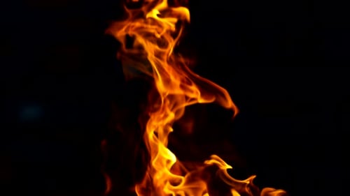 Fire Flames and a Lot of Bright Sparks Are Flying From the Fire at Night