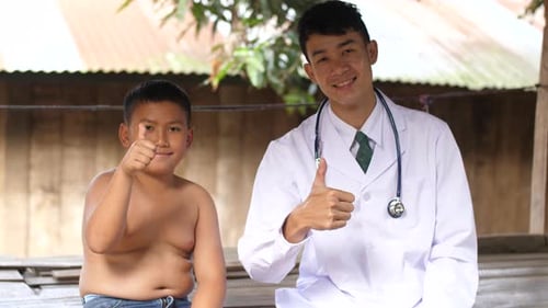Friendly Doctor and Child Giving Thumbs Up