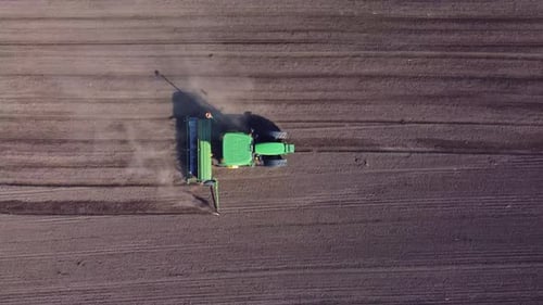 Agricultural Tractor Plows Soil Field for Sowing Aerial Top View From the Drone