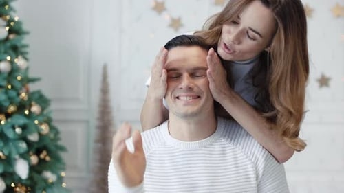 Couple Exchanging Gifts in Holiday Home Setting