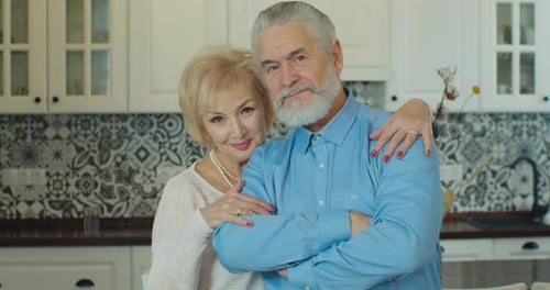 Loving Senior Couple Embracing Indoors at Home