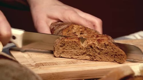 Bread Slicing on a Wooden Cutting Board