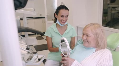 Dentist Shows Patient Her Smile in Mirror