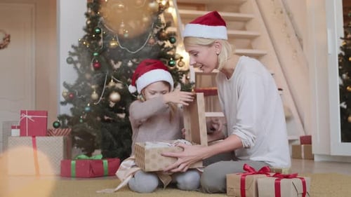 Mother and Child Opening Christmas Present Together