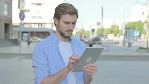 Man Using Tablet in Urban Environment