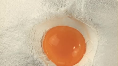 Super Slow Motion in a Pile of Flour Falls a Fresh Egg