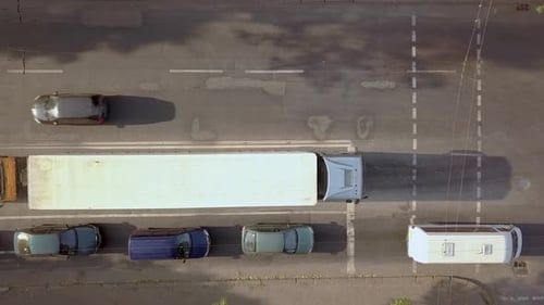 Aerial top down view of busy city street with traffic cars during rush hour.