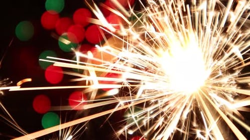 Sparkling Sparklers with Colorful Christmas Light Bokeh