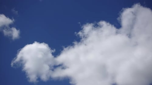 White Clouds Move Slowly Across Blue Sky