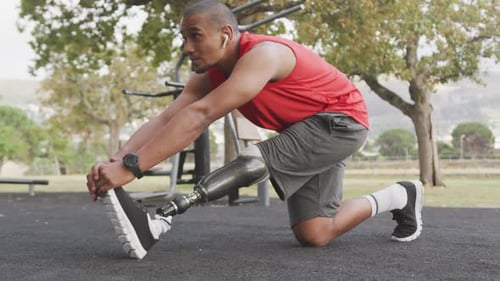 Side view man with prosthetic leg stretching