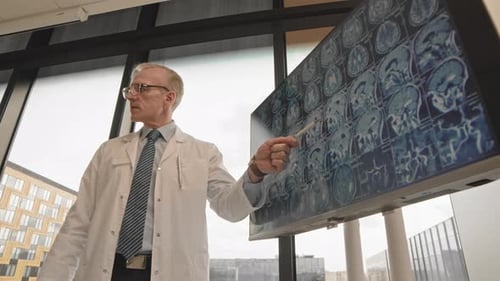 Mature Neurologist Making Presentation in Clinic