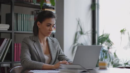 Portrait of Hispanic Woman Typing on Laptop Sends an Email to Client and is Happy with Result