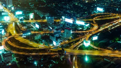 top view of the time lapse of car traffic on the city road at night. The concept of an urban landsca