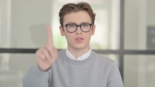 Young Adult Saying No with Finger Gesture